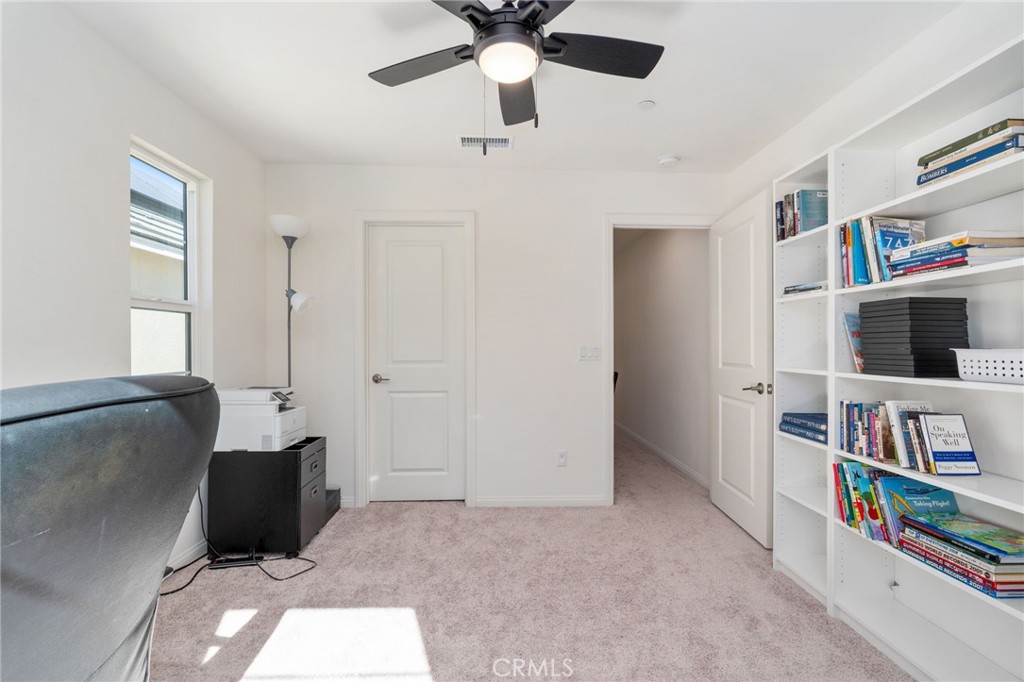 13430 Limestone Drive Yucaipa, CA 92399 - Photo 29 of 30 a living room with furniture and a book shelf
