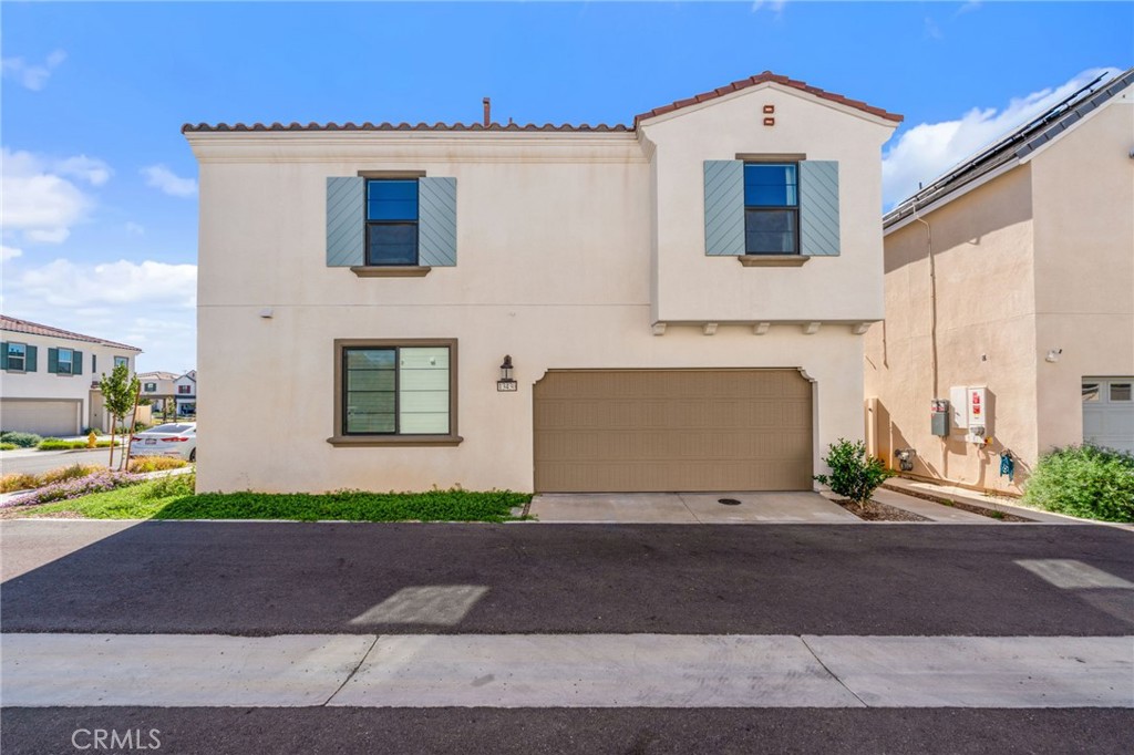 13430 Limestone Drive Yucaipa, CA 92399 - Photo 4 of 30 a front view of a house with a yard and garage