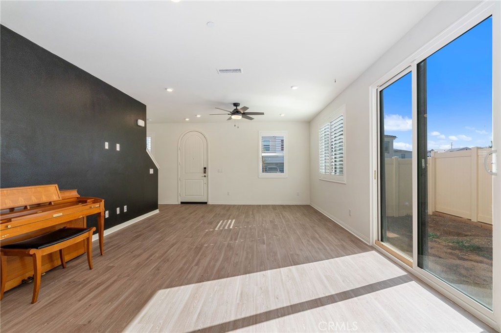 13430 Limestone Drive Yucaipa, CA 92399 - Photo 5 of 30 an empty room with wooden floor and windows