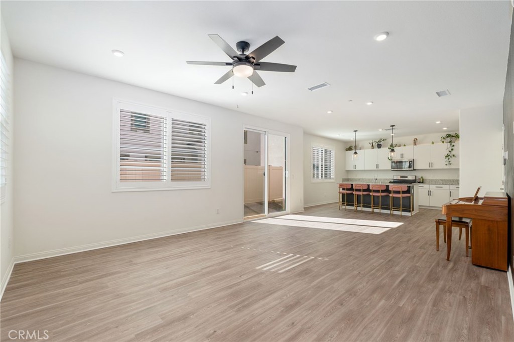 13430 Limestone Drive Yucaipa, CA 92399 - Photo 7 of 30 a view of a kitchen with furniture and wooden floor