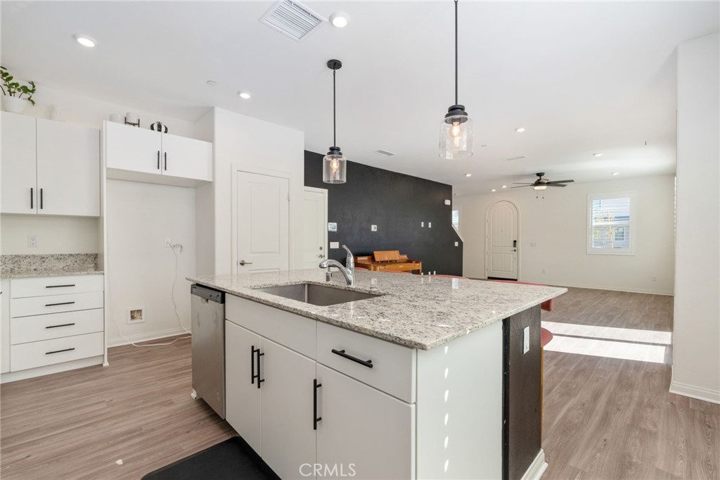 13430 Limestone Drive Yucaipa, CA 92399 - Photo 8 of 30 a kitchen with a sink a counter space and appliances