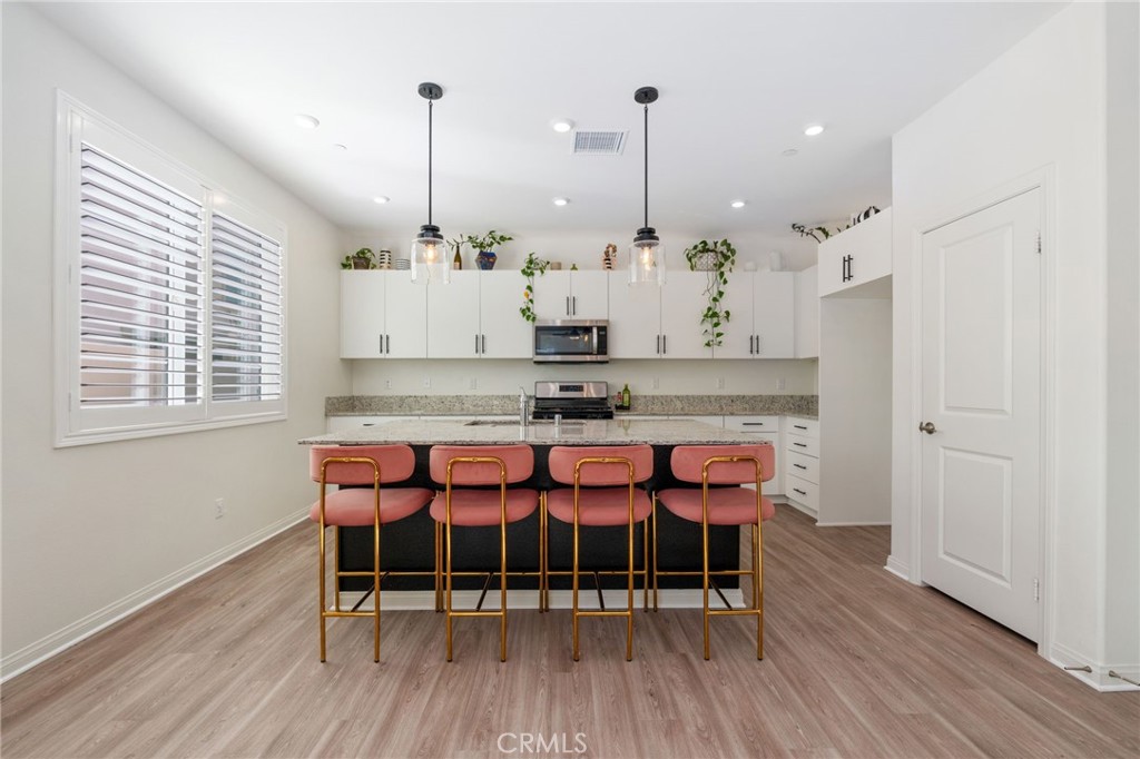 13430 Limestone Drive Yucaipa, CA 92399 - Photo 9 of 30 a view of a room with stainless steel appliances granite countertop wooden floors and sink