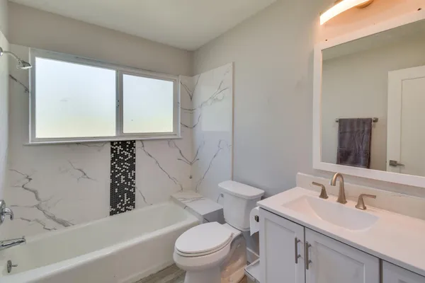 a bathroom with a sink a toilet and a bathtub