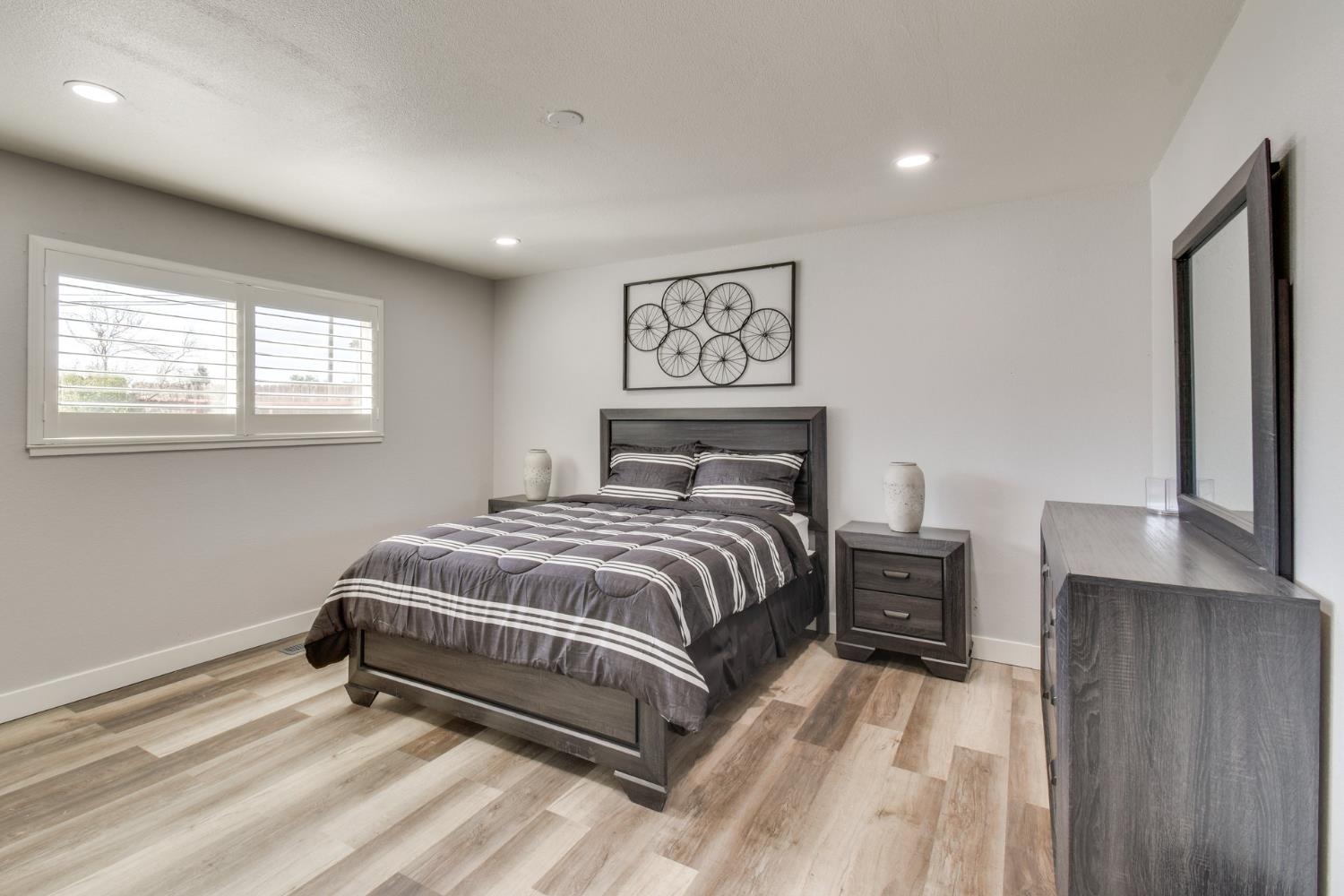 6034 Country Club Place Merced, CA 95340 - Photo 12 of 16 a bedroom with a bed and a night stand