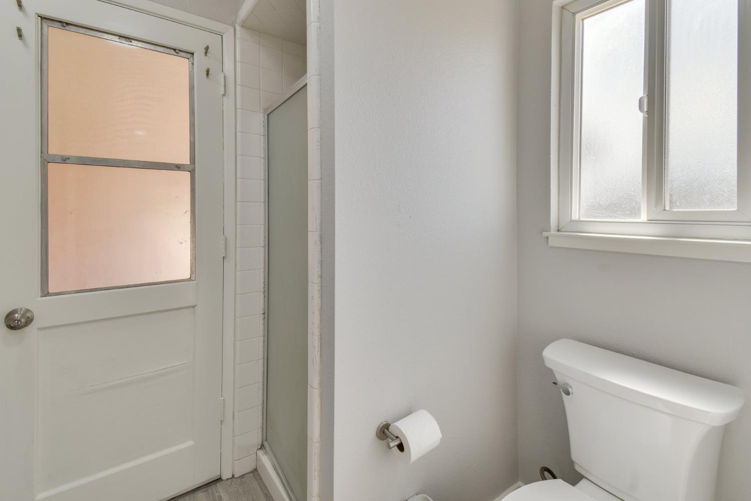 6034 Country Club Place Merced, CA 95340 - Photo 13 of 16 a white toilet sitting next to a window