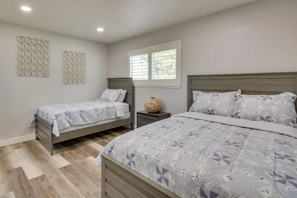 a bedroom with two beds and a couch