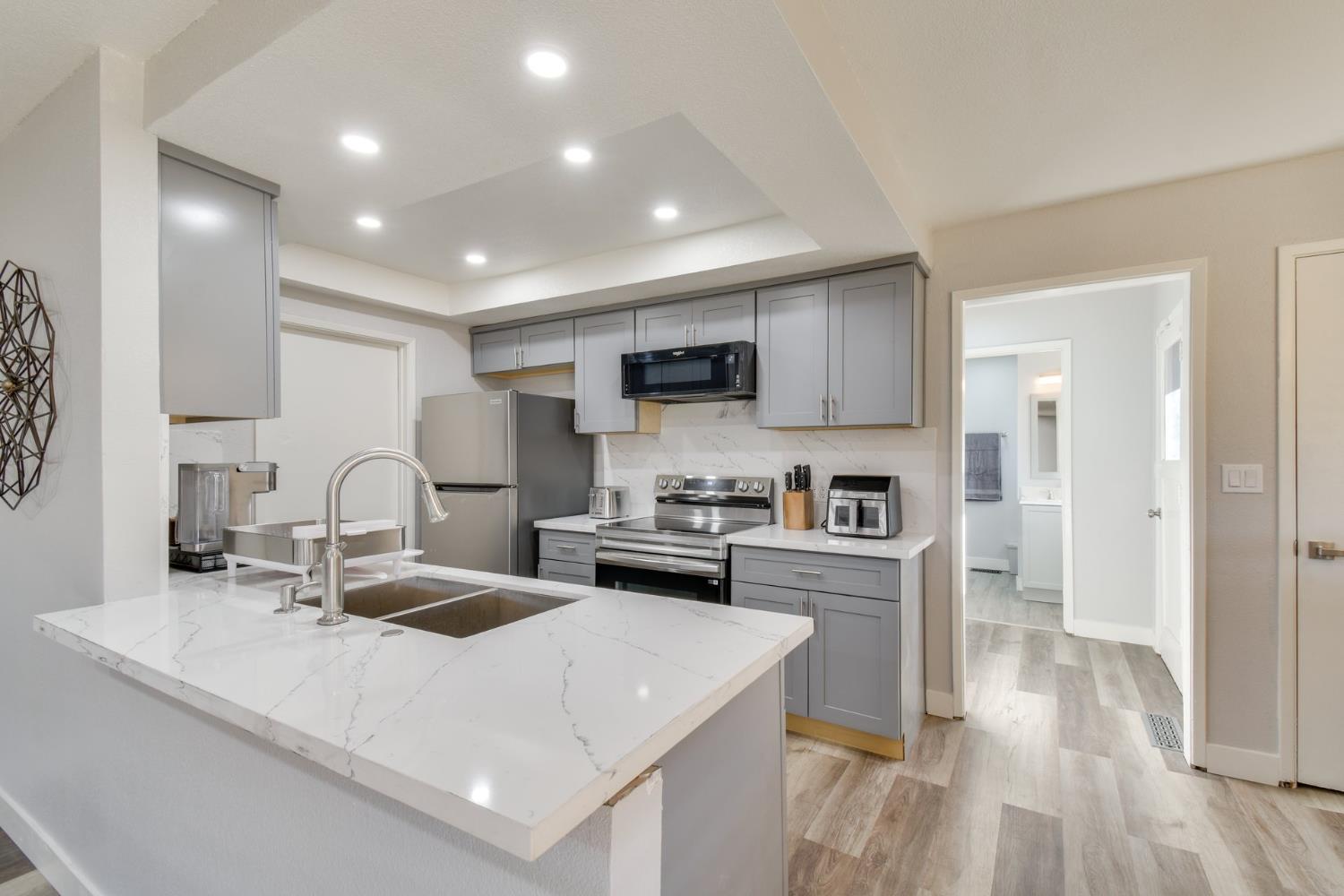6034 Country Club Place Merced, CA 95340 - Photo 4 of 16 a kitchen with stainless steel appliances granite countertop a sink stove and refrigerator