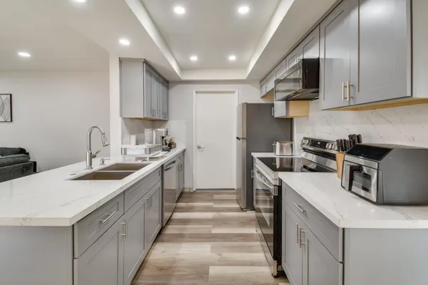 a kitchen with a sink stove and cabinets