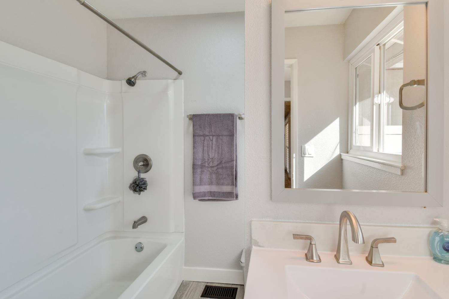 6034 Country Club Place Merced, CA 95340 - Photo 10 of 16 a bathroom with a sink and a bathtub