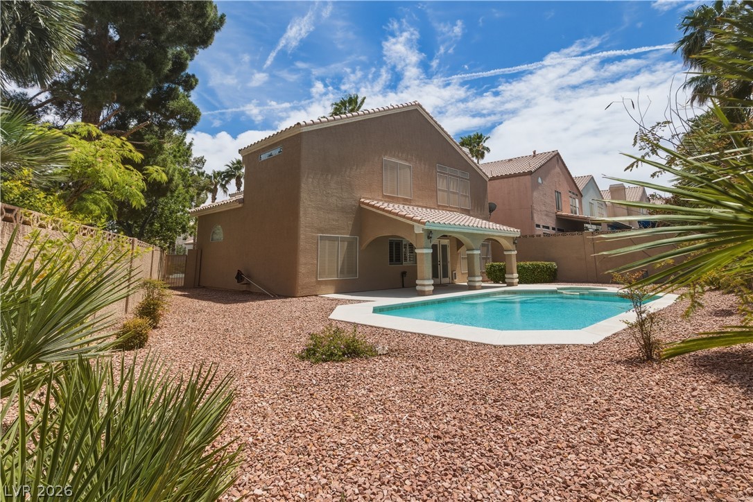 29 Olive Tree Henderson, NV 89074 - Photo 54 of 60 This private yard offers a refreshing pool and an inviting covered patio for relaxation.