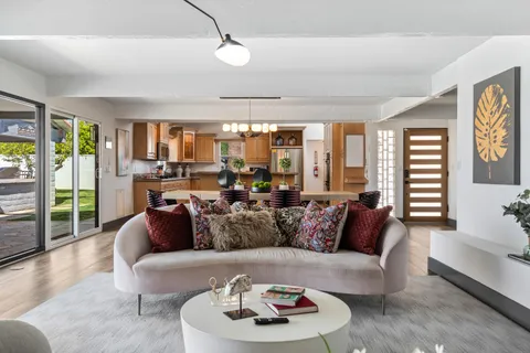 a kitchen with stainless steel appliances granite countertop a sink a stove and a refrigerator