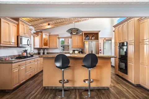a kitchen with a sink refrigerator and cabinets