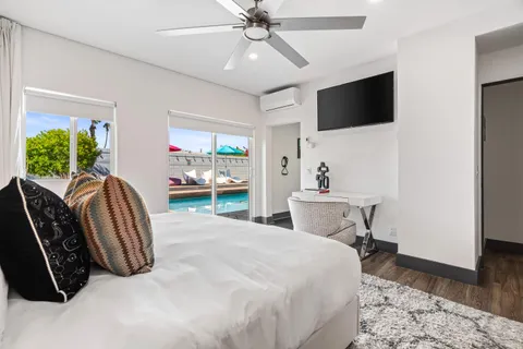 a view of a livingroom with wooden floor and a ceiling fan