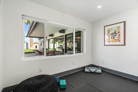 a spacious bathroom with a sink a large mirror and a shower
