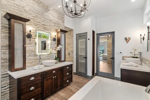 a bedroom with a bed and a couch next to a window