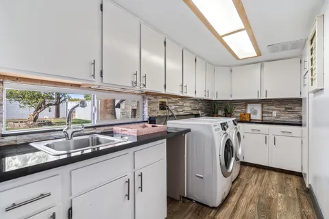 a dining room with furniture and a kitchen view