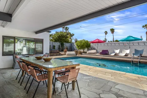 a front view of house with yard and outdoor seating