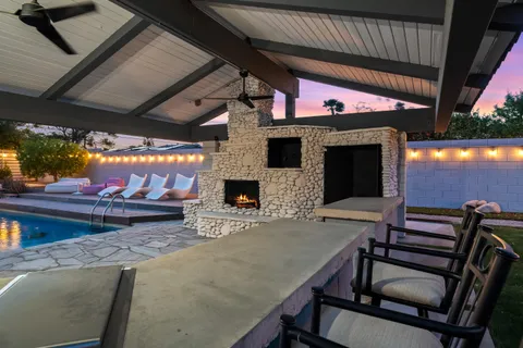 a front view of a house with palm trees