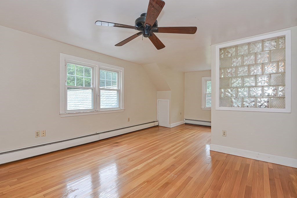 12 Ridgeview Road Sturbridge, MA 01566 - Photo 24 of 40 a view of an empty room with a window and wooden floor