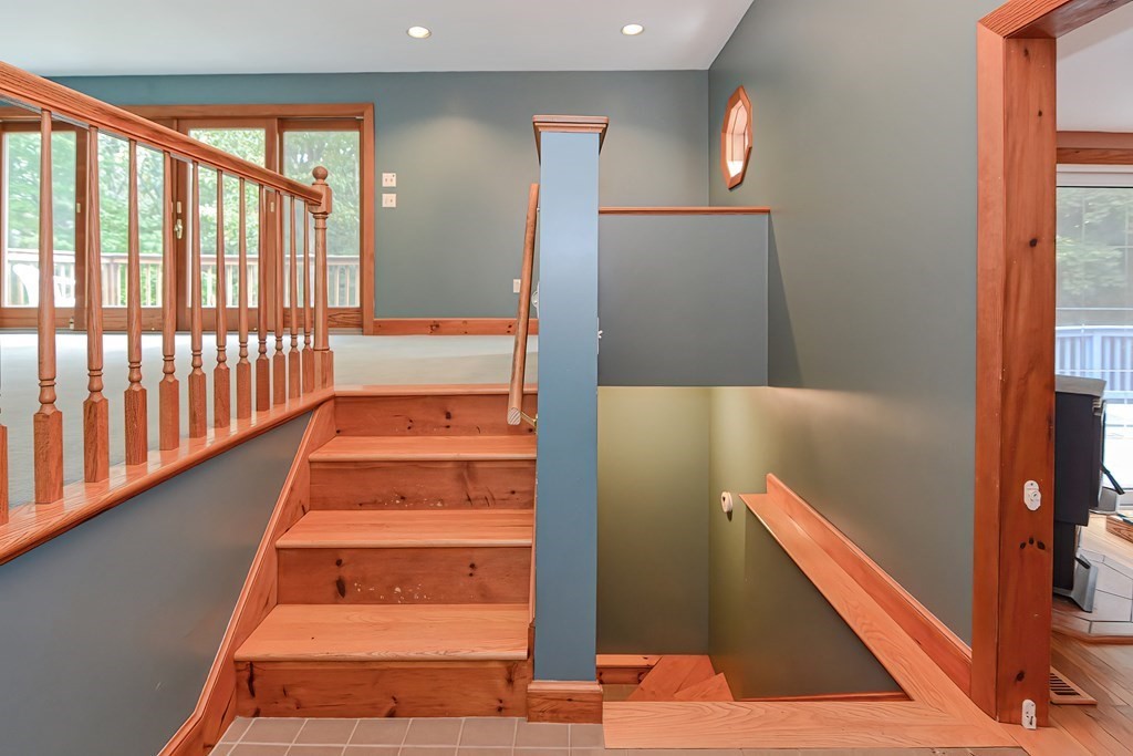 12 Ridgeview Road Sturbridge, MA 01566 - Photo 29 of 40 a view of staircase with lots of frames on wall and a large window