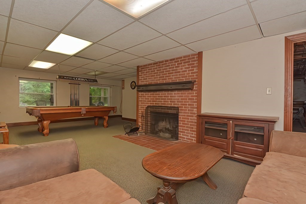 12 Ridgeview Road Sturbridge, MA 01566 - Photo 36 of 40 a bedroom with furniture and a fireplace