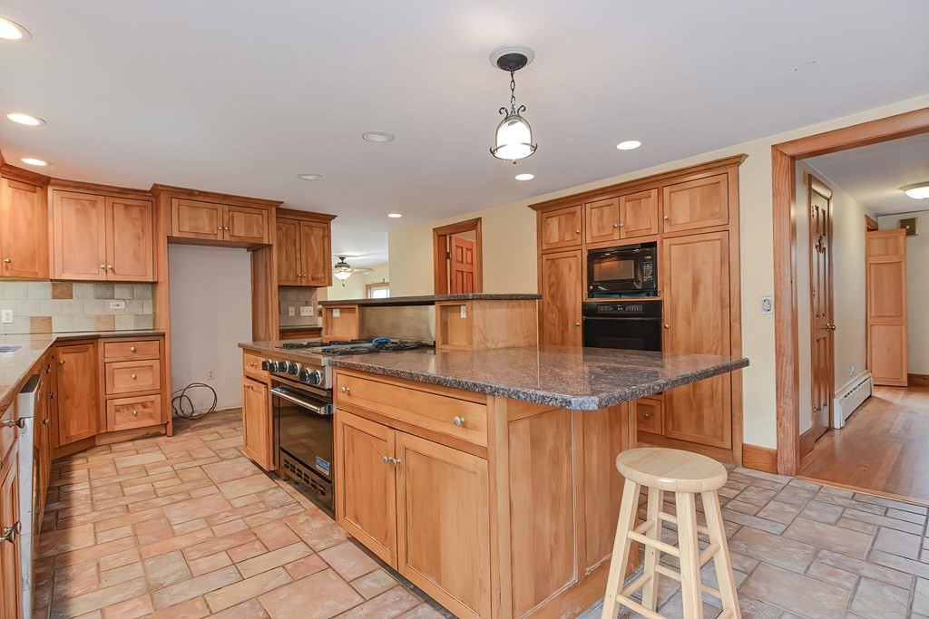12 Ridgeview Road Sturbridge, MA 01566 - Photo 6 of 40 a kitchen with stainless steel appliances granite countertop a stove top oven a sink and a refrigerator