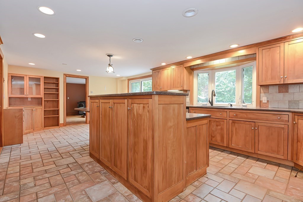 12 Ridgeview Road Sturbridge, MA 01566 - Photo 8 of 40 a kitchen with stainless steel appliances granite countertop a refrigerator and wooden cabinets