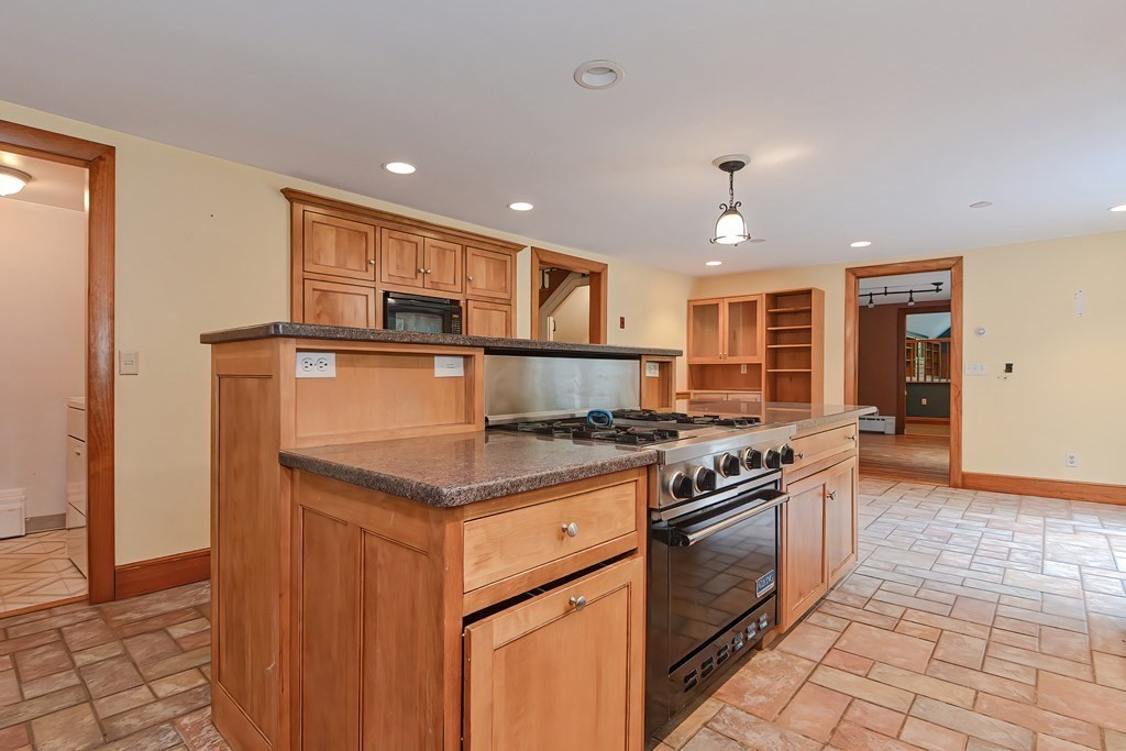 12 Ridgeview Road Sturbridge, MA 01566 - Photo 9 of 40 a kitchen with granite countertop a stove cabinets and stainless steel appliances