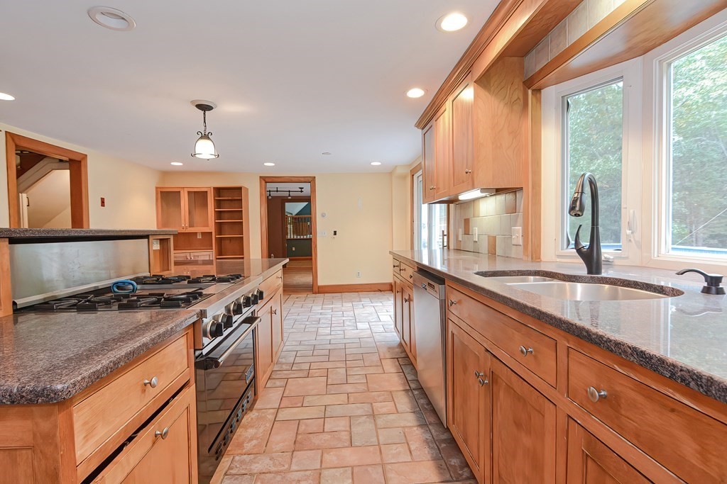 12 Ridgeview Road Sturbridge, MA 01566 - Photo 10 of 40 a kitchen with stainless steel appliances granite countertop a stove a sink and a wooden cabinets