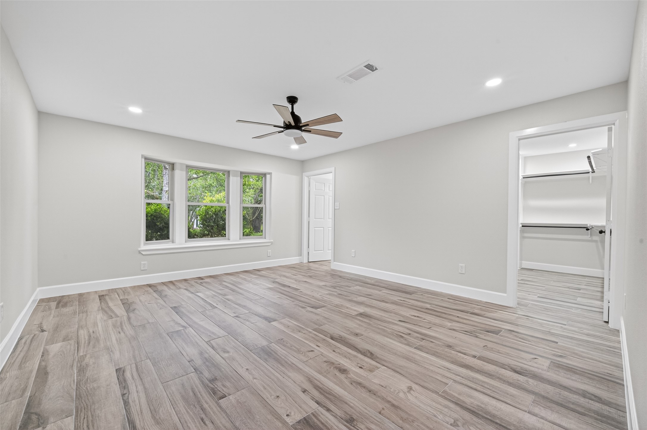 23607 Cardinal Drive Hockley, TX 77447 - Photo 21 of 50 The primary bedroom offers a generous footprint and polished tiled floors, creating a cool, quiet haven illuminated by soft natural light.