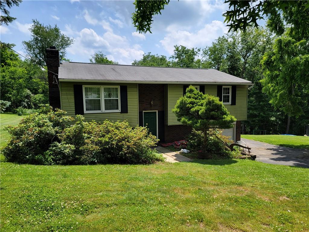 3225 Dutch Ridge Road Beaver, PA 15009 - Photo 1 of 6 a front view of house with a garden