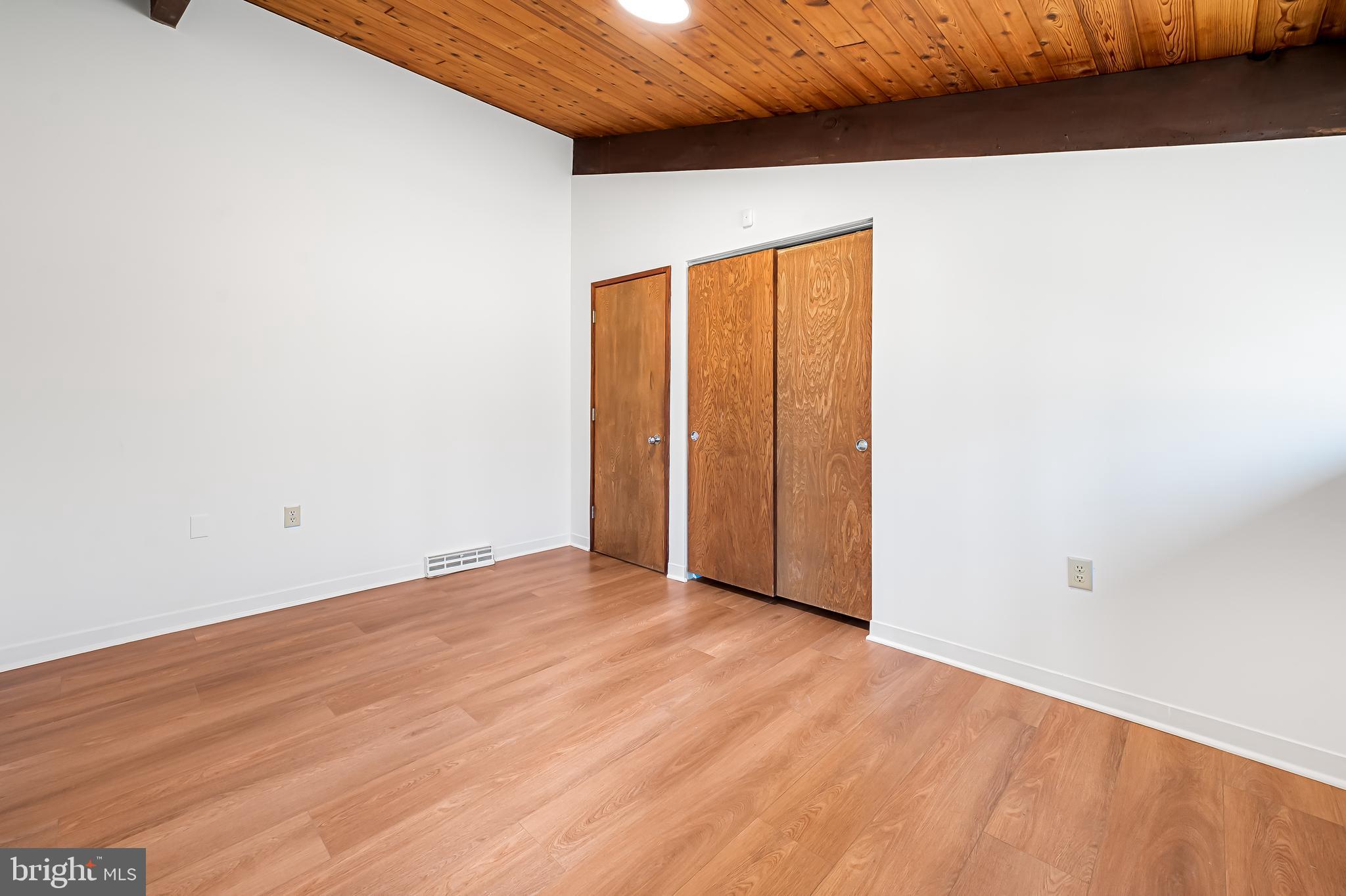 1817 Falls Road Parkton, MD 21120 - Photo 25 of 50 an empty room with wooden floor and windows