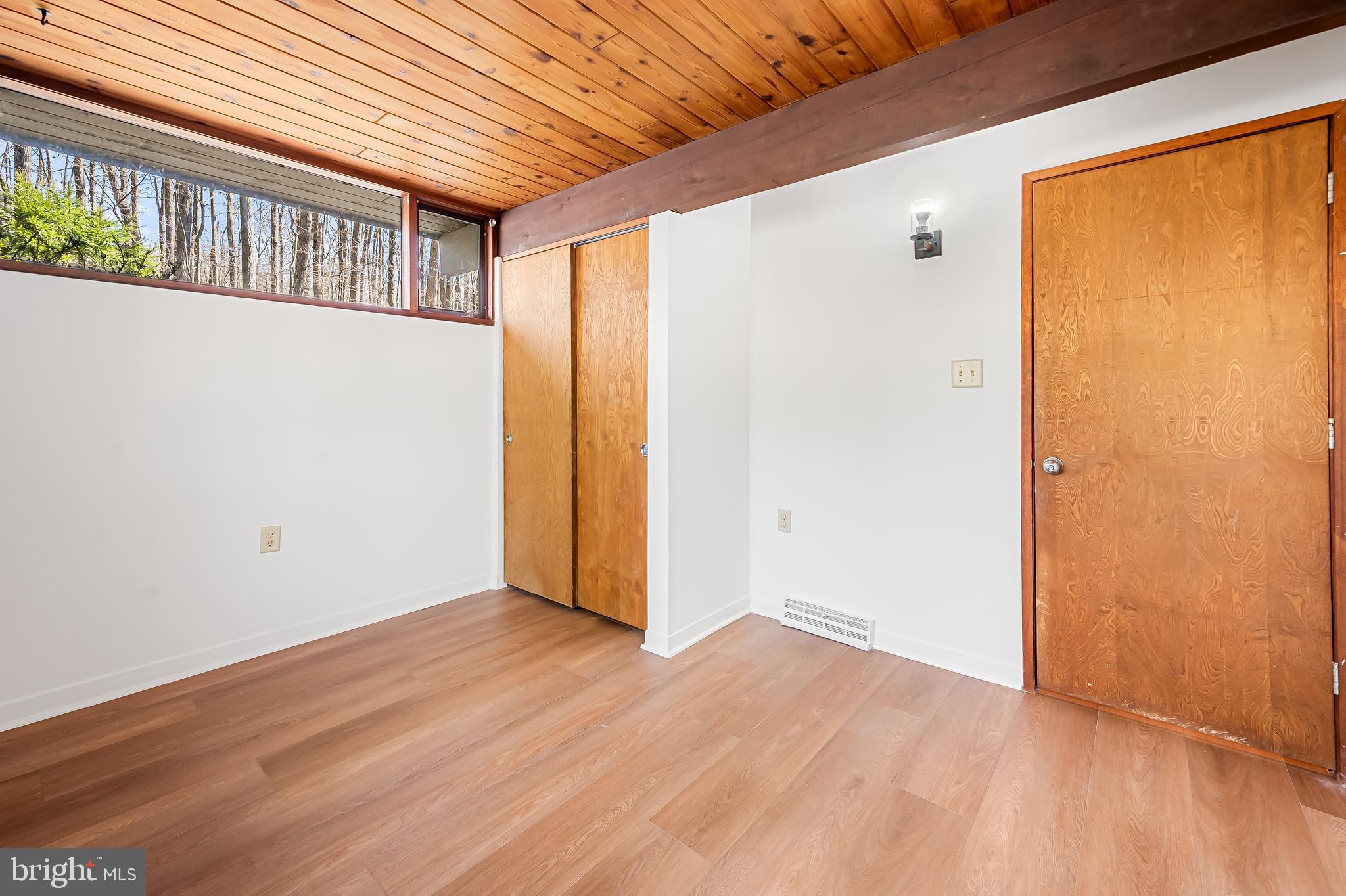 1817 Falls Road Parkton, MD 21120 - Photo 28 of 50 a view of an empty room with wooden floor and a window