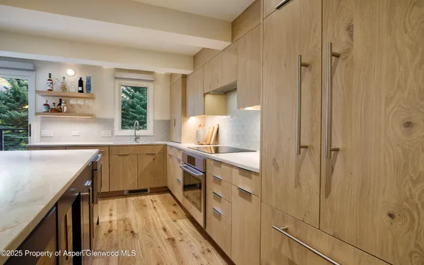 a bedroom with bed and a flat tv screen on a dresser