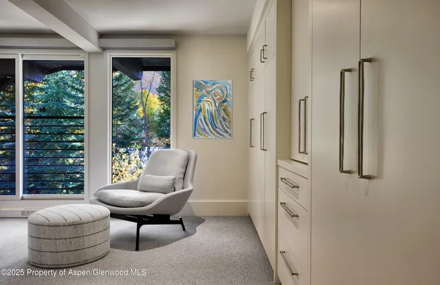 a living room with furniture and a view of bathroom