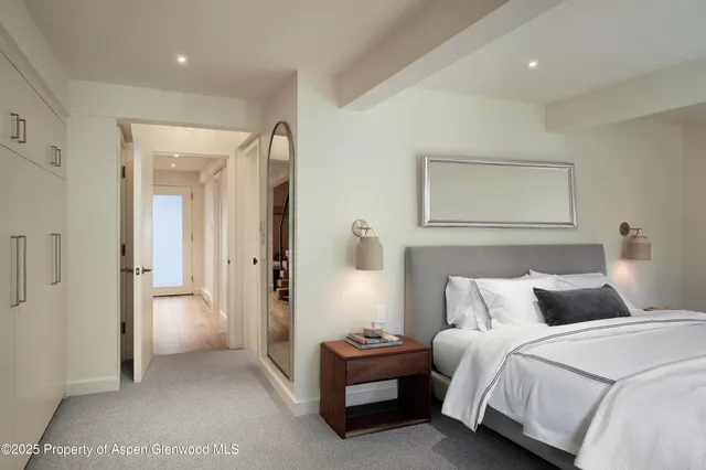 a bedroom with two beds and a large window