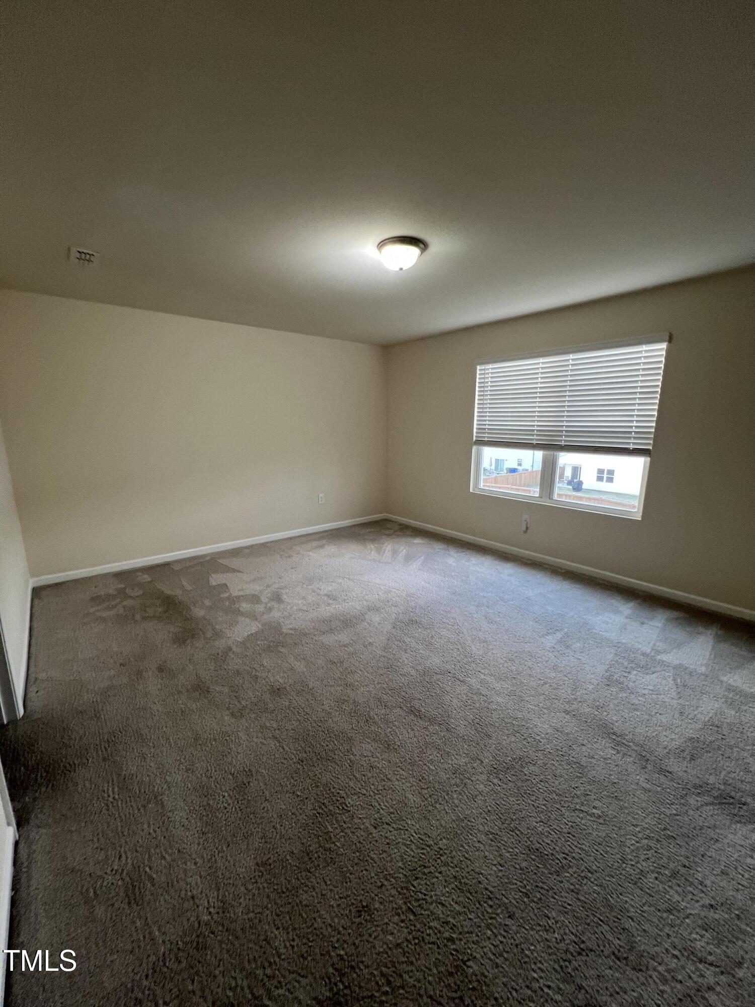 3529 Strawberry Patch Row Raleigh, NC 27604 - Photo 12 of 18 an empty room with windows