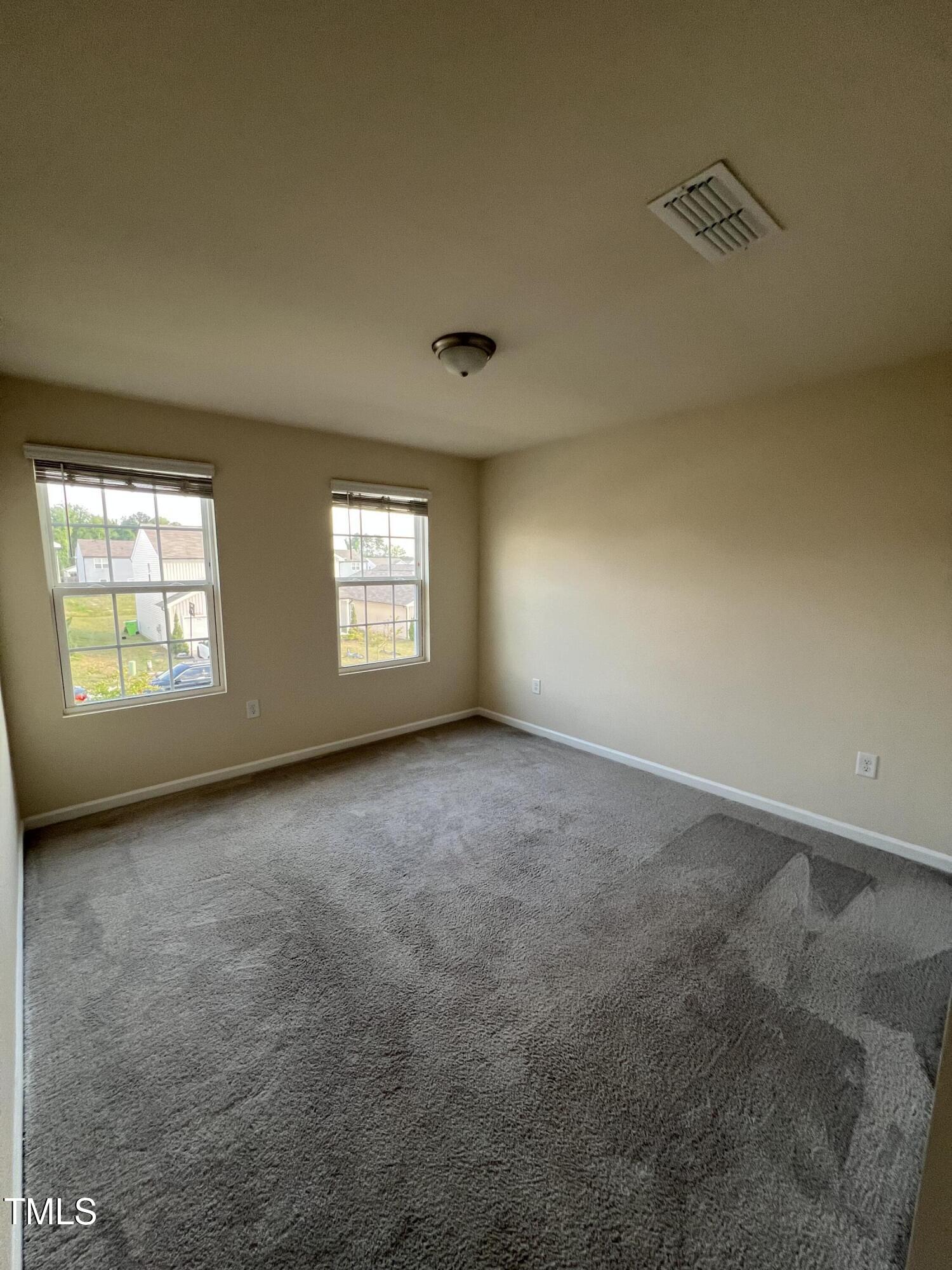 3529 Strawberry Patch Row Raleigh, NC 27604 - Photo 15 of 18 an empty room with windows