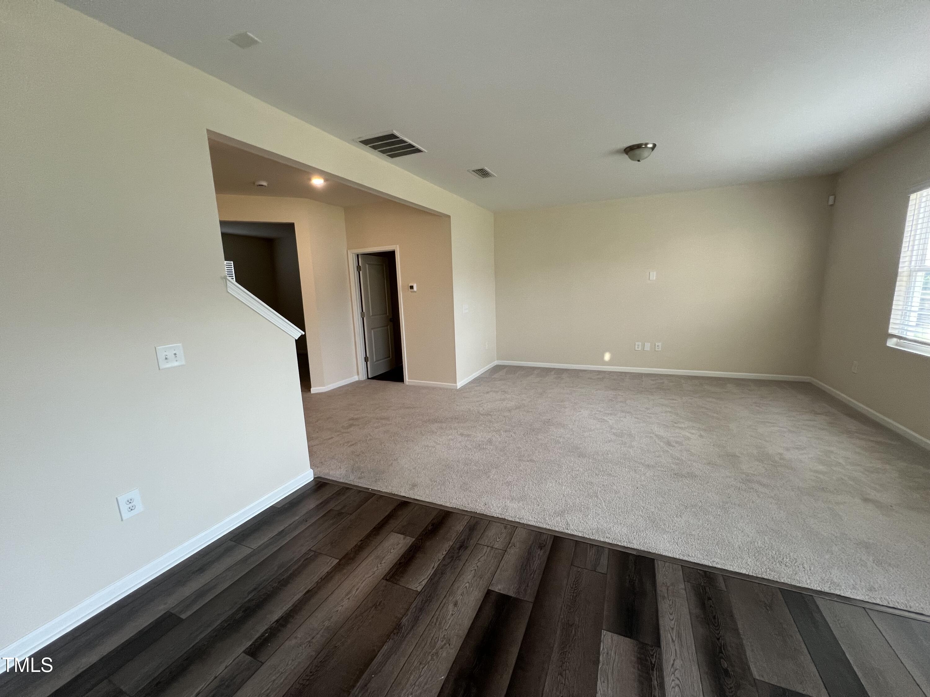 3529 Strawberry Patch Row Raleigh, NC 27604 - Photo 4 of 18 wooden floor in an empty room with a window