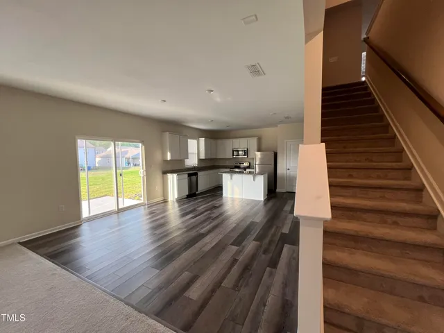 a view of entryway and hall with wooden floor