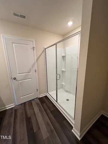 a bathroom with a glass door shower