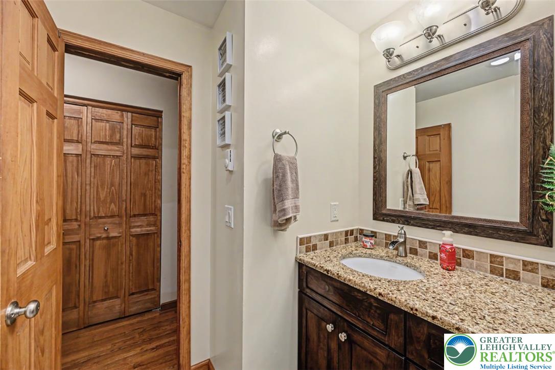 386 Upper Rdg Drive Effort, PA 18330 - Photo 22 of 56 Granite counters and a warm wooden vanity offer functionality in this well-appointed bath.