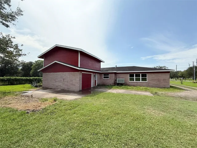 a bathroom with a granite countertop sink toilet and mirror
