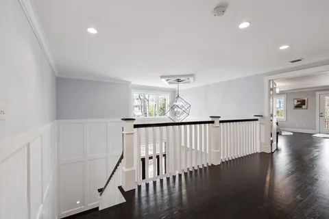 a view of a hallway with wooden floor