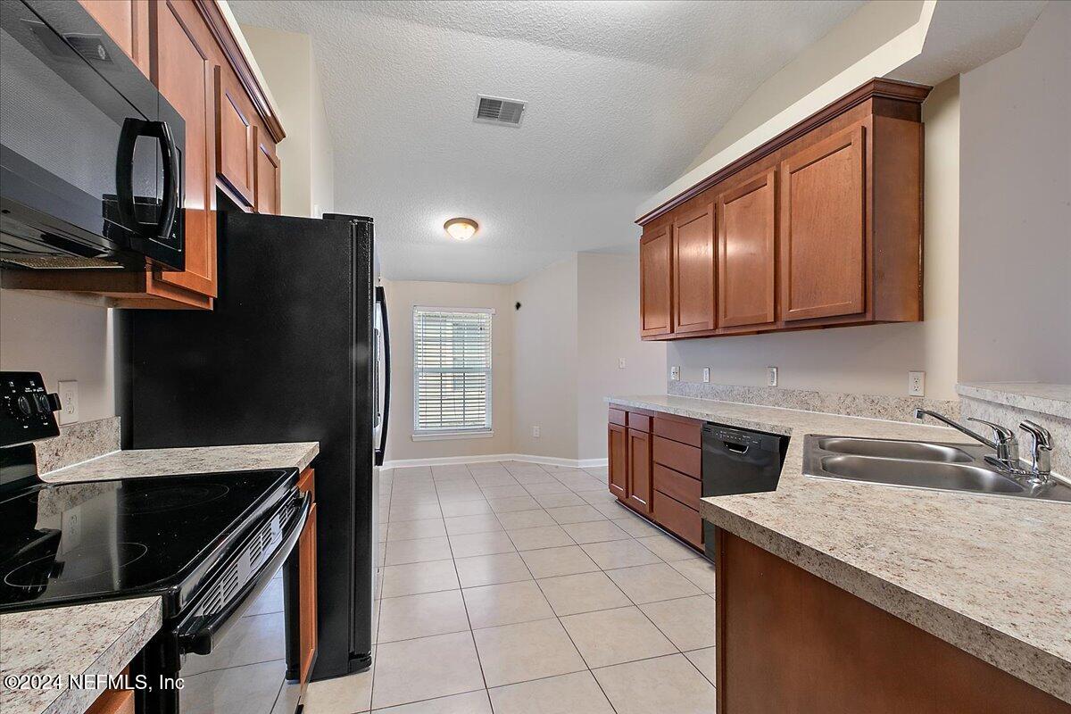 3022 Waters View Circle Orange Park, FL 32073 - Photo 12 of 17 a kitchen with stainless steel appliances granite countertop a sink stove and refrigerator