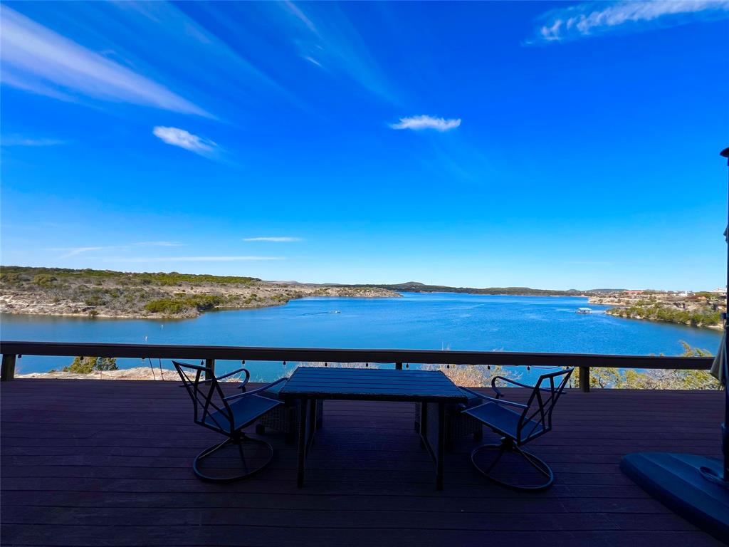 3123 Hells Gate Loop, Unit 45 Strawn, TX 76475 - Photo 13 of 30 a view of a lake with table and chairs