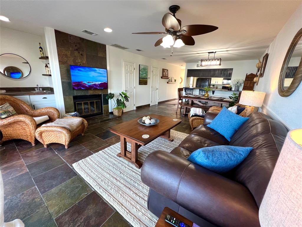 3123 Hells Gate Loop, Unit 45 Strawn, TX 76475 - Photo 3 of 30 a living room with furniture a flat screen tv and kitchen view