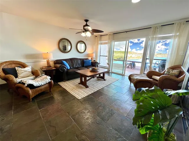 a living room with patio furniture and a large window