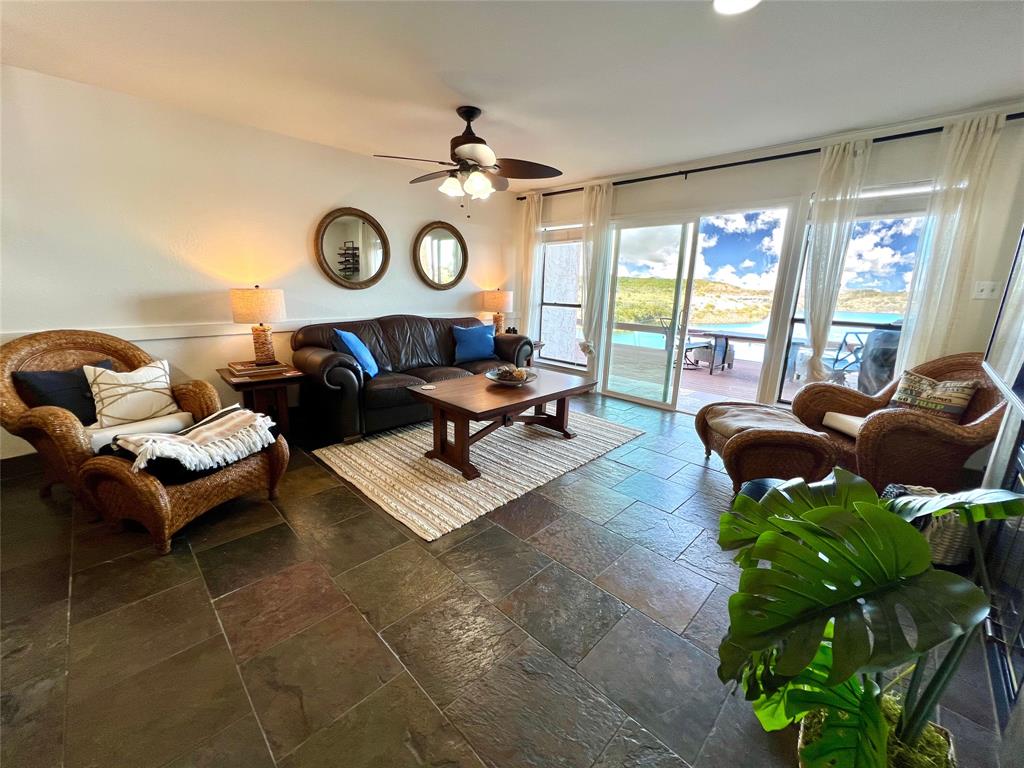 3123 Hells Gate Loop, Unit 45 Strawn, TX 76475 - Photo 5 of 30 a living room with patio furniture and a large window