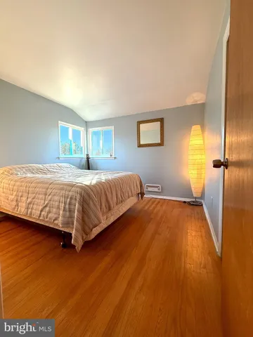 a bedroom with a bed and a night stand